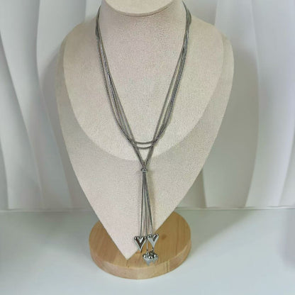 (C122)Collana lunga saliscendi con cuoricini a sonaglio in acciaio inox