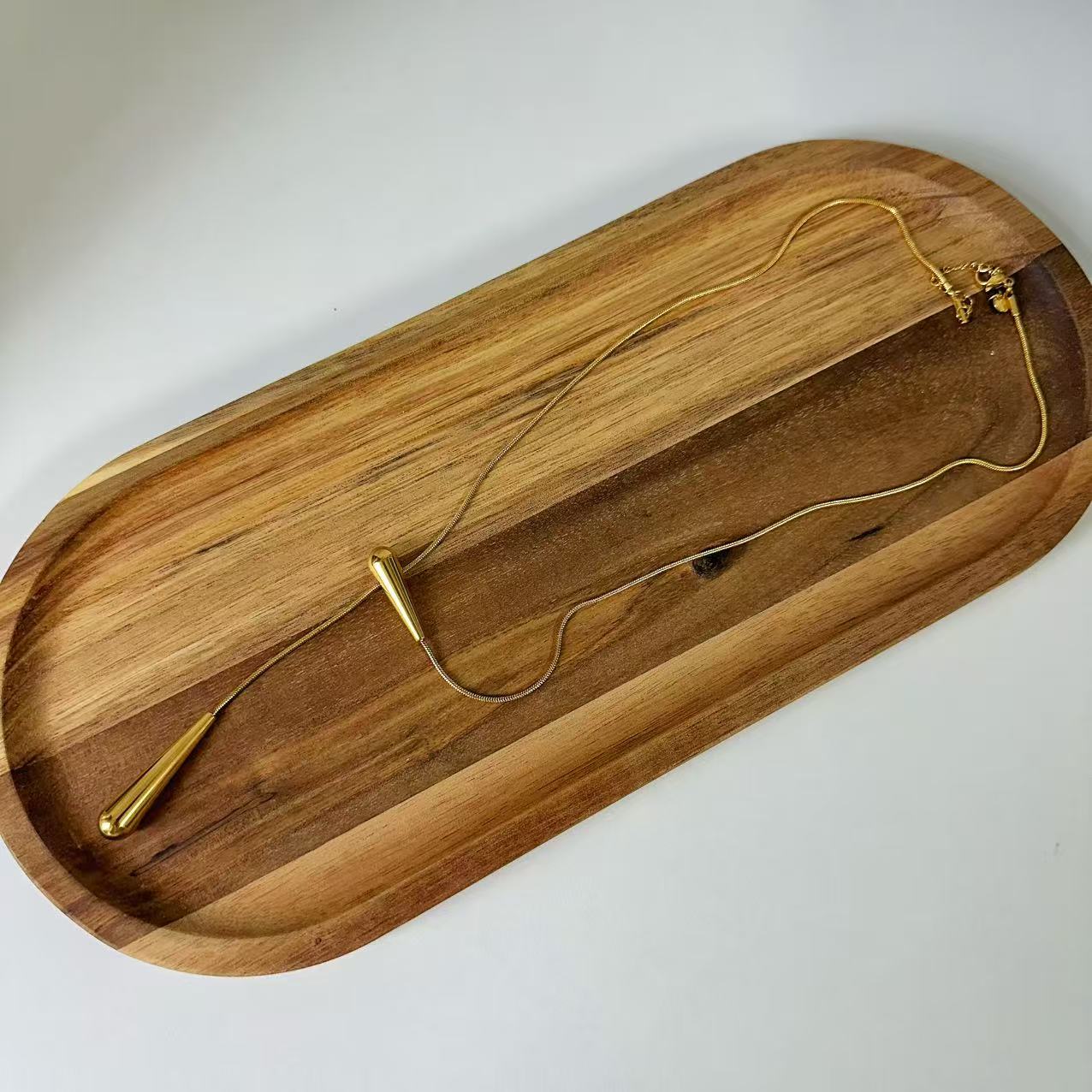 (C124)Collana saliscendi gocce allungate in acciaio inox