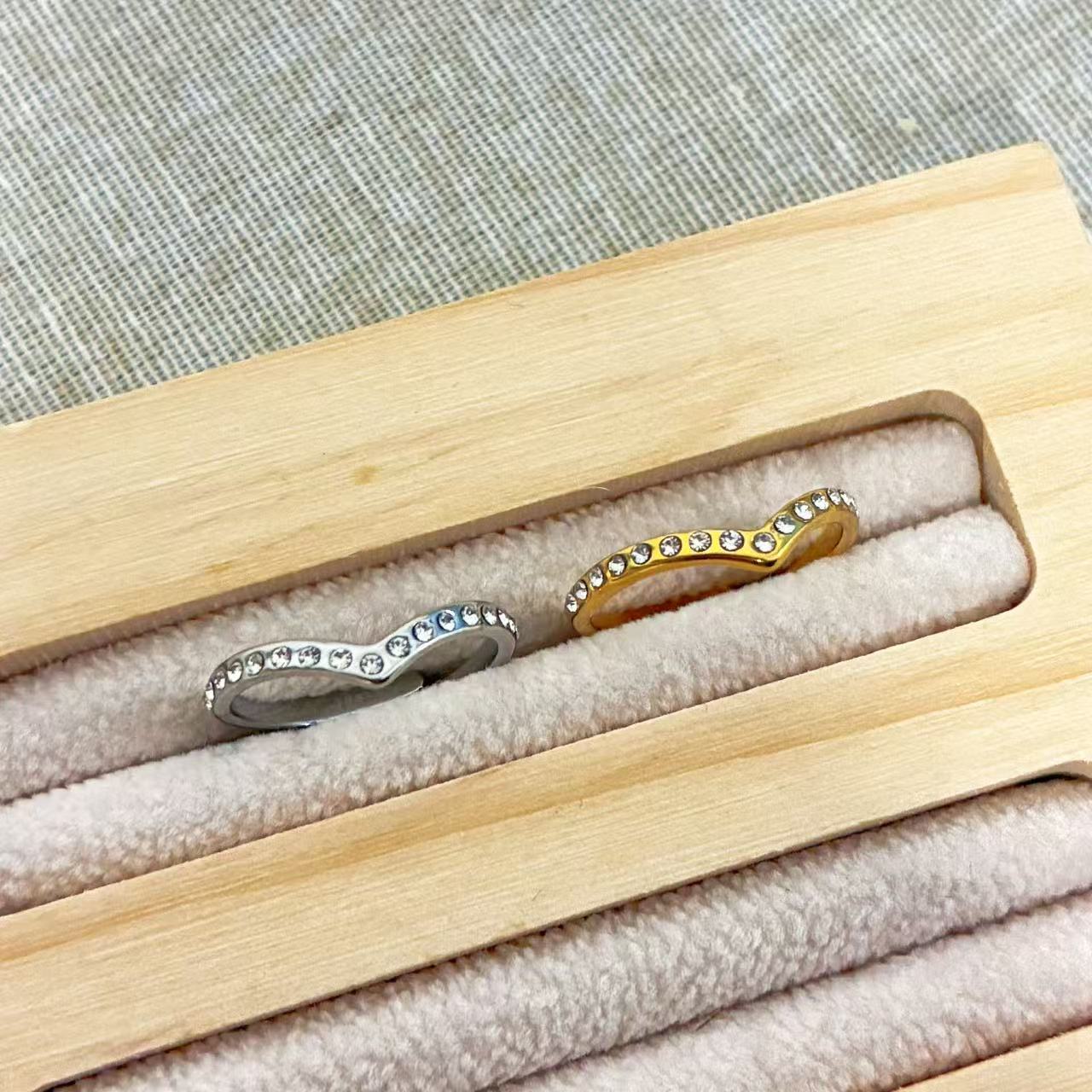 Anello Minimal con Profilo a V e File di Cristalli