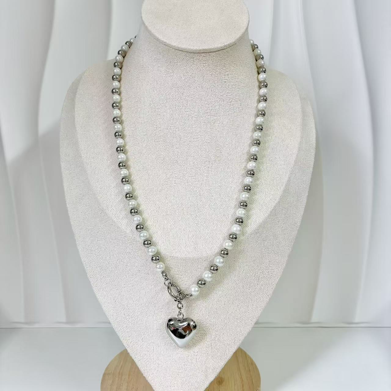 (C219)Collana bicolore con cuore bombato in acciaio inox