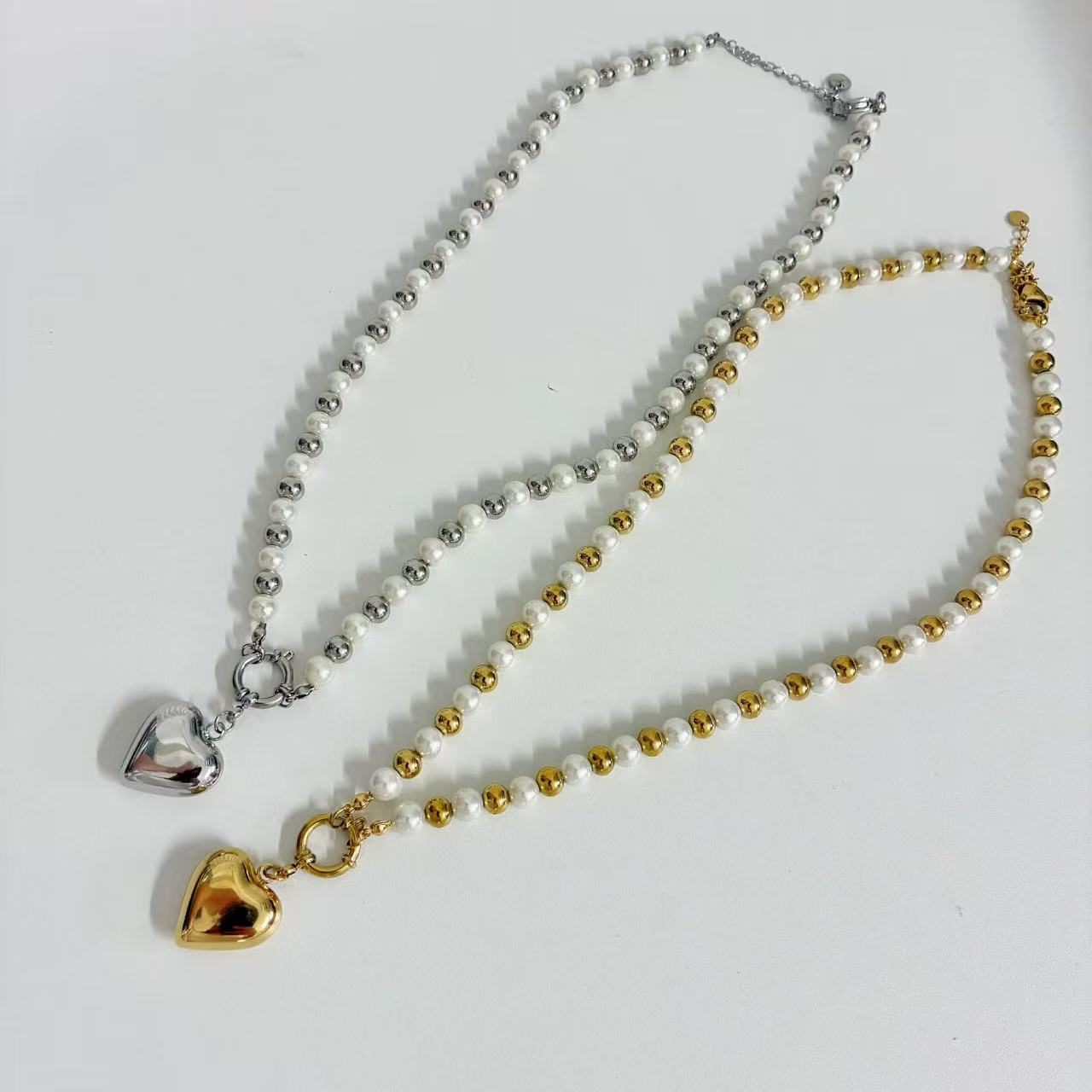 (C219)Collana bicolore con cuore bombato in acciaio inox