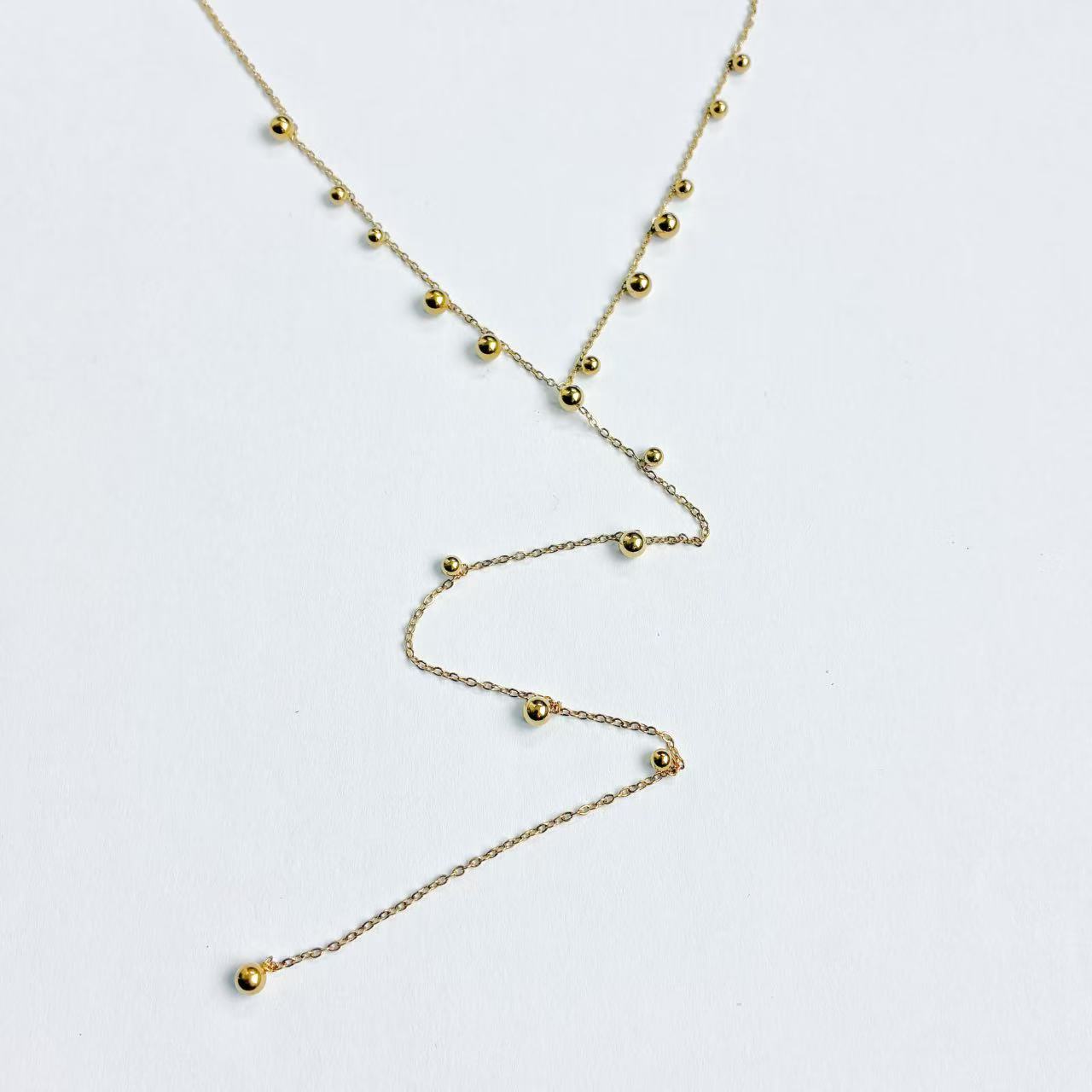 Collana palline con pendente lungo